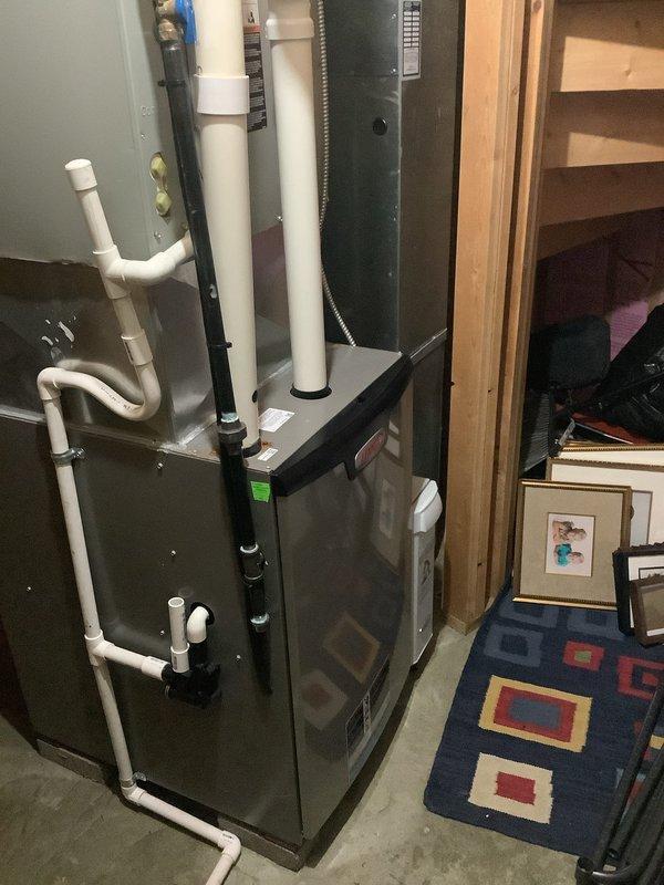 Completed scheduled BS-MVP cooling maintenance visit on residential Lennox HVAC system. Performed comprehensive inspection of indoor furnace unit located in basement utility area and outdoor condenser unit. Verified proper operation of all system components, checked refrigerant levels, inspected electrical connections at both indoor and outdoor units, and confirmed drainage system functionality. All equipment operating within normal parameters with green indicator light showing system status. Unit maintained proper airflow through condenser coils, and PVC venting and drainage piping secure and functioning correctly.