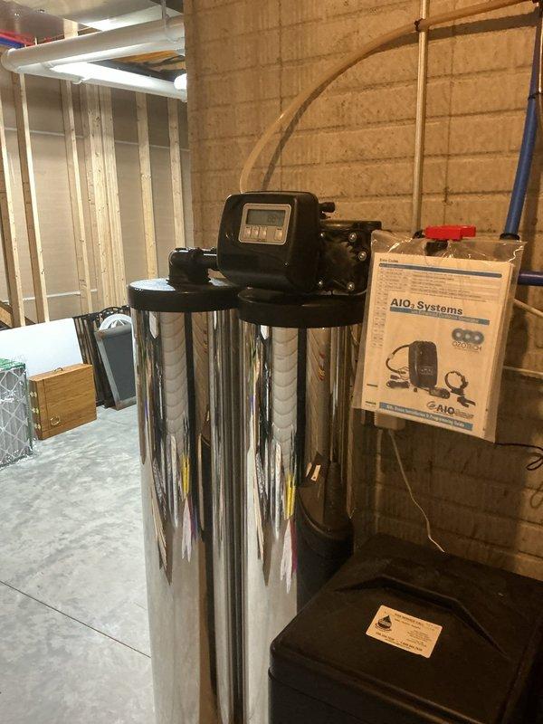 Responded to emergency call for salt tank leaking and flooding basement. Upon arrival, inspected AIO water treatment system including stainless steel filtration tank, brine tank with compromised seal, and associated plumbing connections. Identified leak source at brine tank valve assembly, performed necessary repairs to stop active flooding, and verified all system components including pressure tank, multi-stage filtration housings, and expansion tank were functioning properly with no additional leaks present.