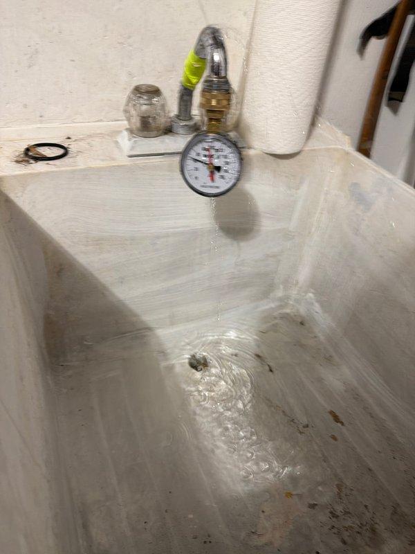 Responded to customer complaint of black particles appearing in bathtub and toilet water. Performed complimentary water quality testing to identify the source of contamination. Conducted exterior inspection at foundation-level hose bib and collected water samples using pressure gauge and testing equipment at utility sink location to analyze water quality and determine appropriate treatment recommendations.