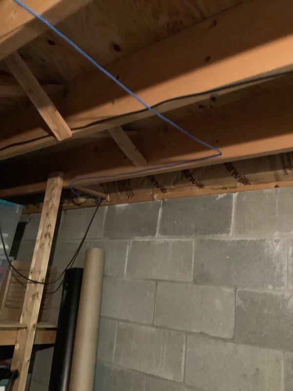Completed electrical estimate and site assessment for car charging station installation project. Evaluated existing electrical infrastructure in basement area, including panel box condition and capacity for required upgrades. Assessed garage outlet configuration to determine necessary improvements for enhanced power distribution. Documented current wiring conditions, exposed floor joists, and electrical routing pathways through foundation areas. Identified structural access points and cable management requirements for future installation work. Provided comprehensive photographic documentation of basement panel location, existing utility runs, and foundation wall conditions to support accurate project planning and material specifications.