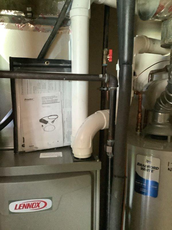 Completed installation of a Lennox 96% AFUE downflow furnace in residential mechanical room. Installed new unit with proper venting using PVC piping, established all necessary utility connections including gas line with shutoff valve, and integrated system with existing Bradford White water heater and copper plumbing infrastructure. Mounted and programmed Aprilaire digital thermostat set to 72°F, verified all safety controls, tested system operation, and confirmed proper airflow and combustion efficiency.