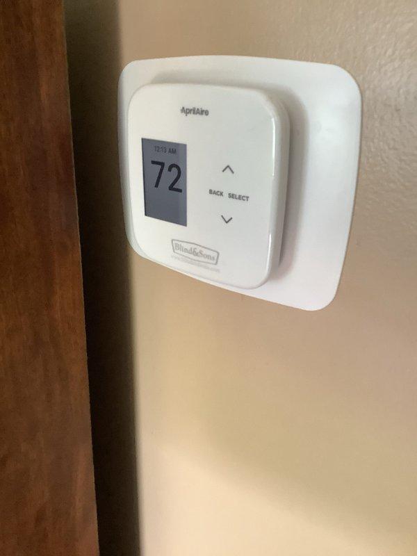 Completed installation of a Lennox 96% AFUE downflow furnace in residential mechanical room. Installed new unit with proper venting using PVC piping, established all necessary utility connections including gas line with shutoff valve, and integrated system with existing Bradford White water heater and copper plumbing infrastructure. Mounted and programmed Aprilaire digital thermostat set to 72°F, verified all safety controls, tested system operation, and confirmed proper airflow and combustion efficiency.