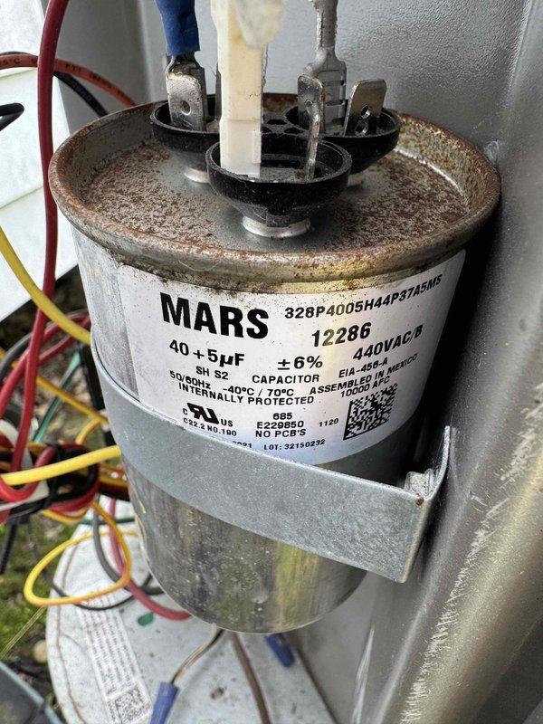 Performed comprehensive tune-up on 6-year-old air conditioning system. Inspected dual-run capacitor (40+5 MFD, 440VAC) and noted corrosion on terminal housing but confirmed proper electrical connections and functionality. Measured system amperage at 6.67A, verifying compressor operation within normal parameters. All electrical connections secured, system tested and operating efficiently.