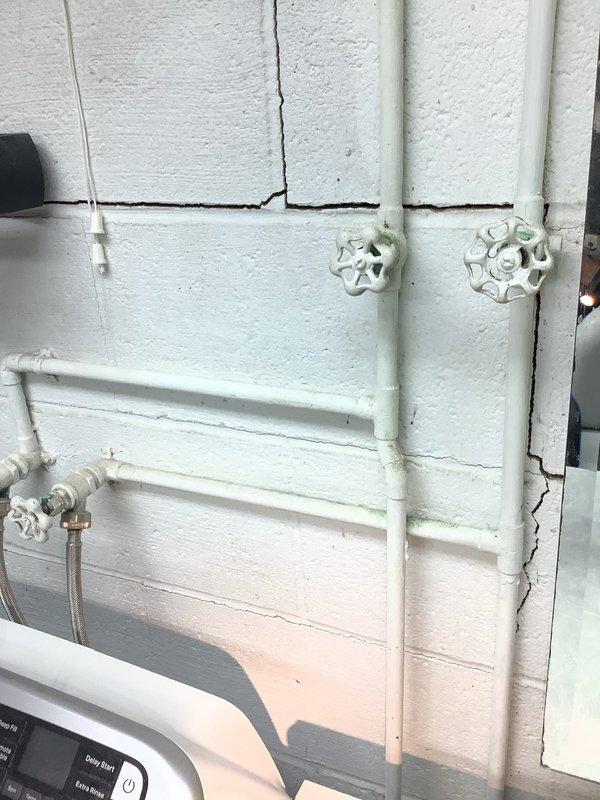 Installed shutoff valves in a 1955-built residence to provide proper water isolation capability. The installation addressed the absence of functional shutoff valves in the existing plumbing system, which included both interior and exterior piping configurations with PVC and copper components.