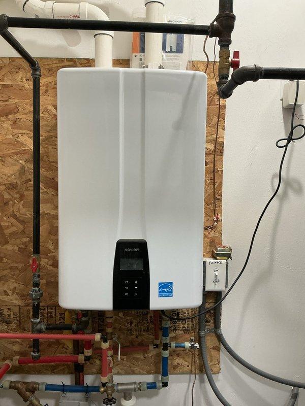 Performed routine maintenance descaling service on Navien NPE series tankless water heater unit. Flushed system with descaling solution to remove mineral buildup and sediment from heat exchanger, ensuring optimal performance and efficiency. Unit tested and confirmed operating within normal parameters upon completion.