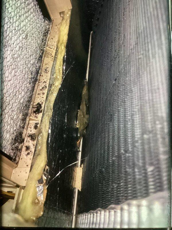 Completed annual tune-up on 2-year-old air conditioning system. Performed comprehensive inspection of evaporator coil assembly, which showed accumulated dirt, debris, and biological growth on metal housing and frame components. Noted degraded yellow fiberglass insulation with compression damage and moisture-related deterioration around coil assembly. Inspected flexible ductwork and filter screen, both showing normal operational dust accumulation. System components remain structurally sound despite age-related surface contamination. Confirmed customer interest in maintenance plan renewal.