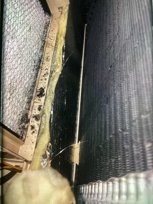 Completed annual tune-up on 2-year-old air conditioning system. Performed comprehensive inspection of evaporator coil assembly, which showed accumulated dirt, debris, and biological growth on metal housing and frame components. Noted degraded yellow fiberglass insulation with compression damage and moisture-related deterioration around coil assembly. Inspected flexible ductwork and filter screen, both showing normal operational dust accumulation. System components remain structurally sound despite age-related surface contamination. Confirmed customer interest in maintenance plan renewal.