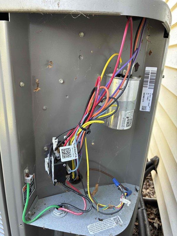 Completed annual preventative maintenance on one-year-old cooling system. Inspected electrical disconnect box and verified all wire connections, capacitors, and control components were secure and functioning properly. Cleaned condenser coil fins which showed accumulation of dirt, dust, and environmental debris to restore proper airflow and heat transfer efficiency.
