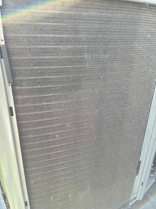 Completed annual preventative maintenance on one-year-old cooling system. Inspected electrical disconnect box and verified all wire connections, capacitors, and control components were secure and functioning properly. Cleaned condenser coil fins which showed accumulation of dirt, dust, and environmental debris to restore proper airflow and heat transfer efficiency.