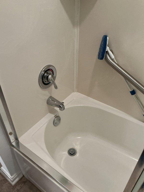Responded to service call for bathtub diverter malfunction where the tub spout diverter lever was stuck in the down position and unable to engage to redirect water flow to the shower head. Inspected the chrome tub spout assembly and diverter mechanism, confirmed the diverter was frozen due to mineral buildup and corrosion preventing proper operation. Successfully freed and restored functionality to the diverter system, allowing proper water diversion between tub spout and shower head.