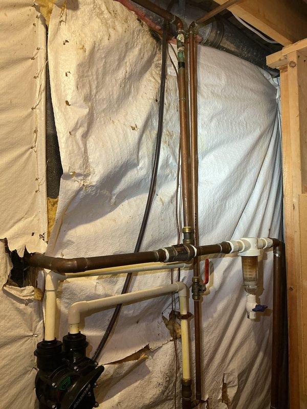 Secured loose garbage disposal unit by realigning and properly mounting beneath kitchen sink. Installed new shut-off valve on main water supply line to provide isolation capability for future maintenance and emergency shutdowns.