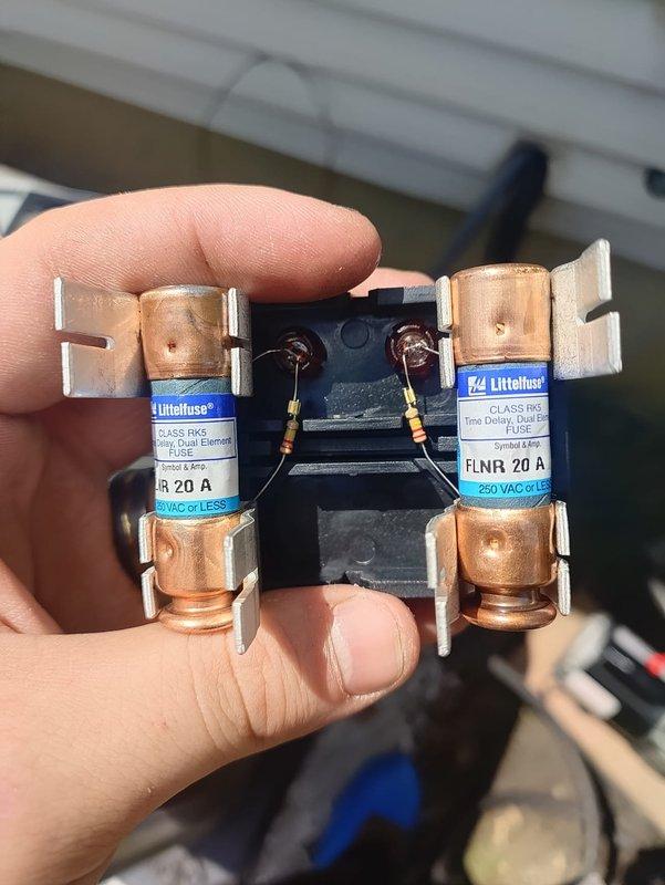 Completed second-phase installation of residential air conditioning system and evaporator coil. Replaced dual-element time-delay fuses (FLNR 20A, Class RK5, 250VAC) in outdoor disconnect as part of electrical safety verification and system commissioning.