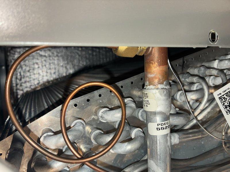 Completed scheduled cooling maintenance visit on 3-year-old air conditioning system. Performed electrical diagnostics using digital multimeter to verify system voltage and amperage readings at the air handler unit. Inspected evaporator coil assembly, refrigerant lines, and copper piping connections for proper operation and condition, noting oxidation on copper components consistent with normal system age.
