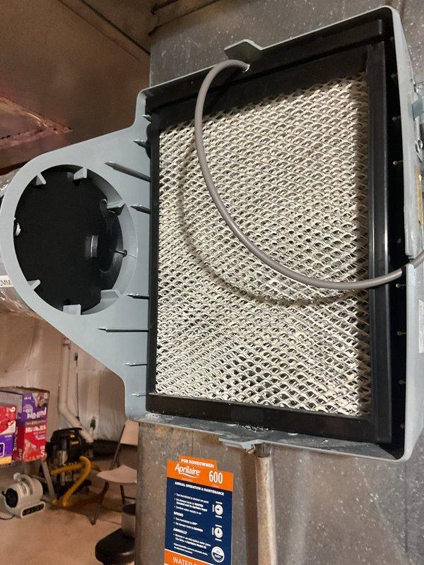 Completed scheduled cooling system maintenance visit on 6-year-old air conditioning unit. Performed comprehensive inspection of evaporator coil and heat exchanger, which showed normal wear with minor dust accumulation on fins but remained in functional condition. Inspected and evaluated Aprilaire 600 whole-home humidifier system including fan motor assembly and filter media condition. All major HVAC components were photographed, assessed for proper operation, and found to be functioning within normal parameters for the system's age.