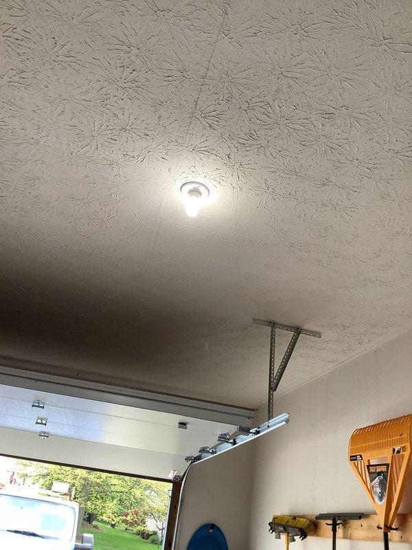 Responded to service call for non-functioning garage light fixture. Customer had already attempted to replace bulbs with no success, indicating fixture failure. Upon inspection, diagnosed faulty ceramic light socket assembly in ceiling-mounted fixture. Removed defective porcelain lamp holder from recessed ceiling fixture and replaced with new socket assembly. Verified proper electrical connections, tested fixture operation, and confirmed restored functionality. Garage lighting now operating normally.