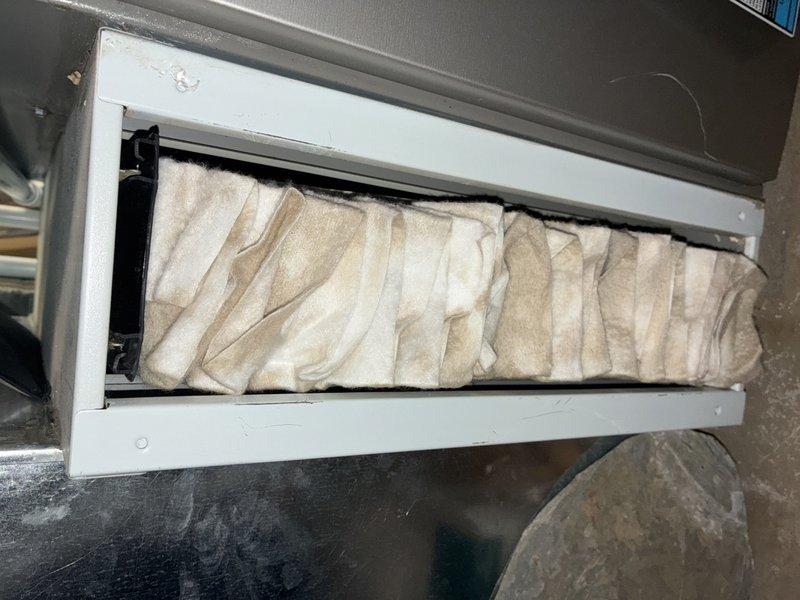 Completed BS-MVP preventive maintenance cooling visit on 5-year-old air conditioning system. Inspected evaporator coil compartment and condensate drain line, documenting conditions with photos showing accessible filter housing and drain opening with minor sediment accumulation. System operational and customer notified upon arrival as requested.