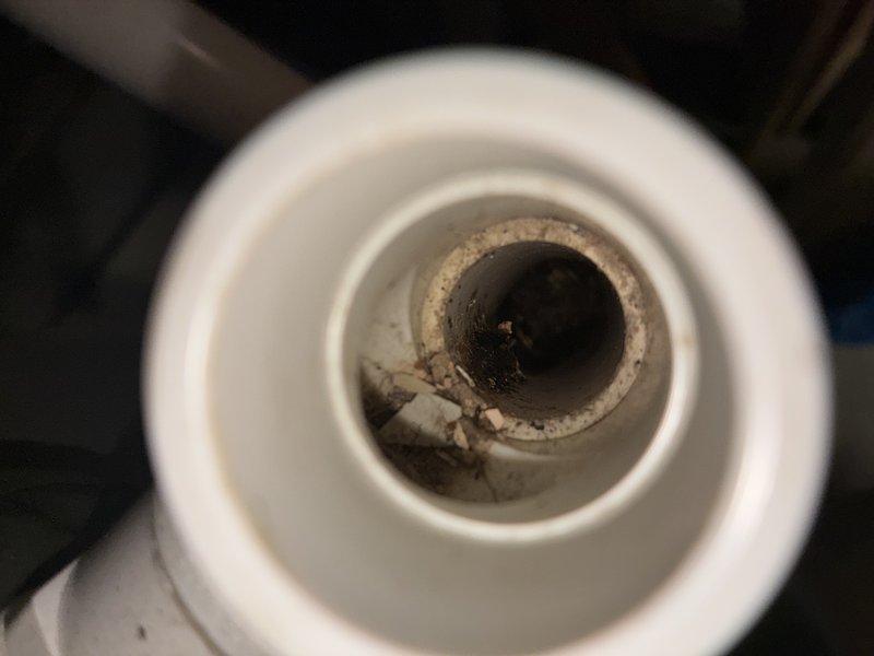 Completed BS-MVP preventive maintenance cooling visit on 5-year-old air conditioning system. Inspected evaporator coil compartment and condensate drain line, documenting conditions with photos showing accessible filter housing and drain opening with minor sediment accumulation. System operational and customer notified upon arrival as requested.