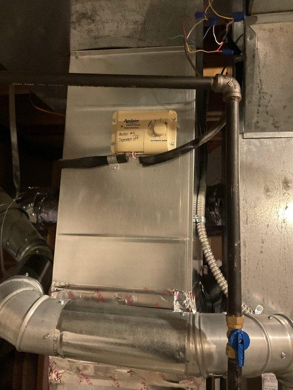 Replaced defective humidistat control on Aprilaire humidifier system mounted to air handler unit. Removed old control, installed new humidistat, verified proper wiring connections, and tested system operation to ensure proper humidity control functionality.