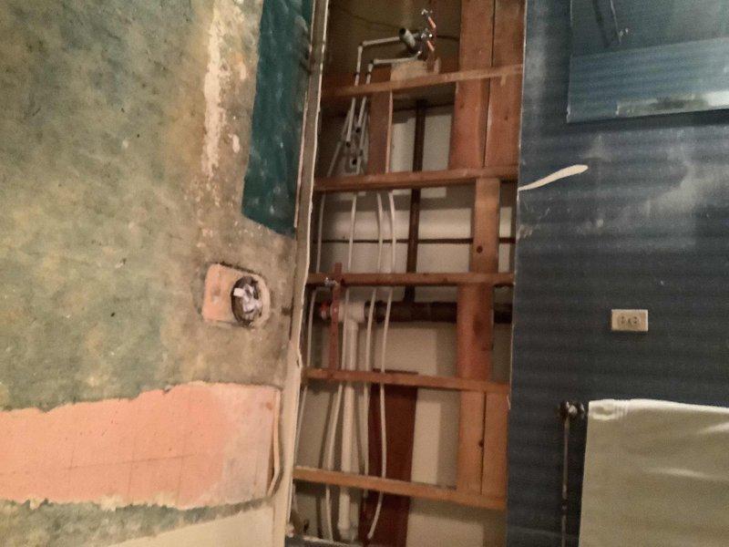 Completed comprehensive plumbing renovation across three areas of the residence. In the main bathroom, removed existing vanity and toilet, opened wall 36 inches above floor level, and installed new PEX water lines with copper stub outs for lavatory and toilet connections. Adapted copper drain line to accommodate new cabinet dimensions for customer-provided fixtures.

In the small bathroom and laundry area, installed new washer box with adaptation to existing copper drain behind wall and provided new washer hoses. Ran new water lines to toilet and sink with stops and supply lines. Removed existing vanity and prepared connections for installation of customer-provided fixture and faucet.

In the mechanical room, removed existing water heater and replaced with 40-gallon tall atmospheric vent unit. Replaced main water valve with homeowner coordinating municipal requirements. Constructed new manifold system for hot and cold water distribution, incorporating isolation valves for main bathroom