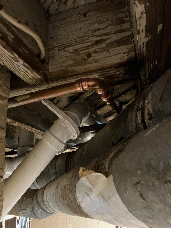 Responded to a water leak in the plumbing system of an approximately 50-year-old residential property. Upon inspection of the crawlspace area, located the source of the leak in the copper supply line running between floor joists. The affected pipe showed signs of age-related deterioration consistent with the home's vintage infrastructure. Repaired the compromised section of copper piping and verified all connections were secure and leak-free. Confirmed proper operation of surrounding plumbing systems including PVC drain lines and verified no additional moisture damage to adjacent wooden structural members or HVAC ductwork in the confined space.