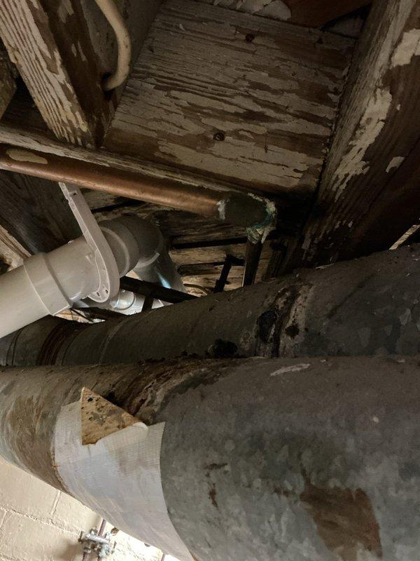 Responded to a water leak in the plumbing system of an approximately 50-year-old residential property. Upon inspection of the crawlspace area, located the source of the leak in the copper supply line running between floor joists. The affected pipe showed signs of age-related deterioration consistent with the home's vintage infrastructure. Repaired the compromised section of copper piping and verified all connections were secure and leak-free. Confirmed proper operation of surrounding plumbing systems including PVC drain lines and verified no additional moisture damage to adjacent wooden structural members or HVAC ductwork in the confined space.
