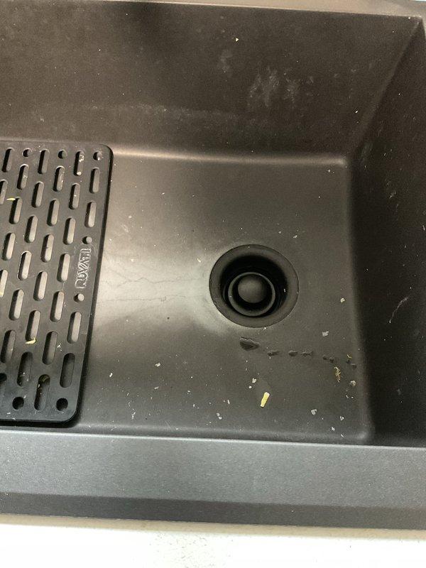 Responded to kitchen sink drainage issue. Upon inspection, identified complete blockage in drain line beyond P-trap assembly. Accessed plumbing system through cabinet base and confirmed obstruction was located downstream of trap, requiring extended cable augering. Successfully cleared blockage using professional drain snake equipment, restoring full drainage capacity. Tested system with water flow to verify complete clearance and proper drainage speed. Left work area clean with all plumbing connections secure and leak-free.