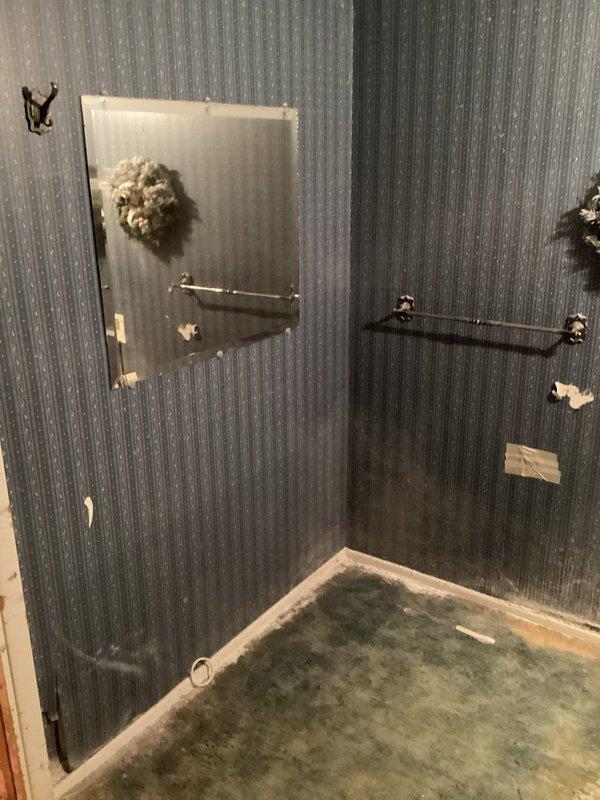 Completed free electrical estimate for bathroom rewiring project. Assessed existing electrical fixtures including outlet and switch mounted on textured wall panel, evaluating conditions and determining scope of work needed to coordinate with plumbing installation scheduled for early May. Documented current electrical configuration and accessibility features including multiple grab bar installations to ensure proper electrical planning for renovated bathroom space.