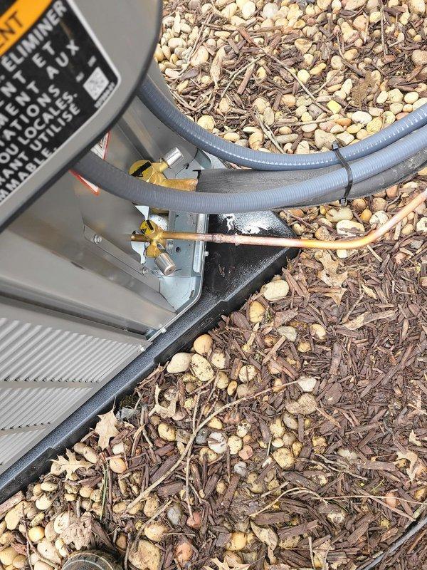 Completed installation of new Lennox air conditioning system with outdoor condensing unit and evaporator coil. Unit was positioned on composite base pad over prepared gravel bed adjacent to residence, with refrigerant lines properly insulated and routed along exterior wall to indoor coil location. System startup performed, refrigerant charge verified, and all electrical connections secured per manufacturer specifications.