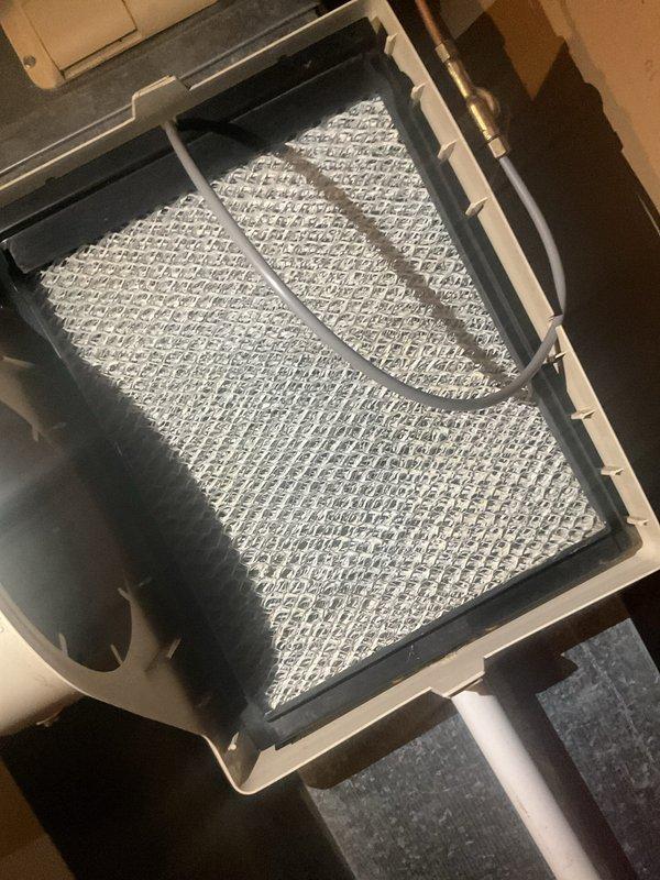 Completed scheduled maintenance visit on a 5-year-old residential air conditioning system. Performed comprehensive inspection of outdoor condenser unit, noting weathered exterior mesh screening with discoloration and dirt accumulation. Inspected indoor air handler and verified pleated air filter condition, which appeared clean and functional with no excessive dirt buildup requiring immediate replacement. Unit operating within normal parameters at time of service.