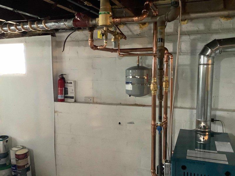 Installation failed initial inspection due to improper expansion tank support—both tanks were supported only by their connected piping rather than approved mounting brackets as required by code. Work placed on hold pending receipt of proper support hardware, with follow-up appointment scheduled for bracket installation and re-inspection once parts arrive.