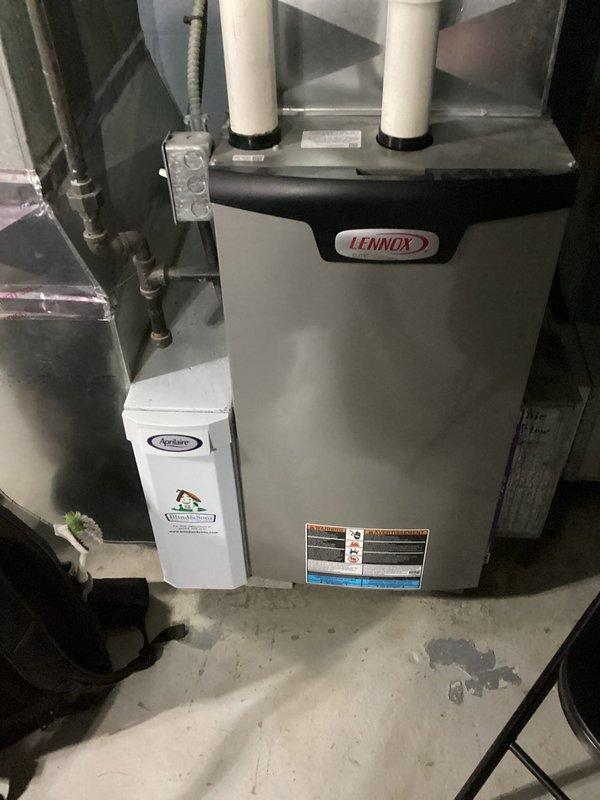 Completed scheduled maintenance visit on 6-year-old Lennox HVAC system for MVP customer. Performed comprehensive inspection of outdoor disconnect box and electrical connections, verifying proper fuse installation and secure terminal connections. Inspected indoor furnace unit with attached Aprilaire humidifier, confirmed all PVC vent pipes properly secured and system components operating within normal parameters.