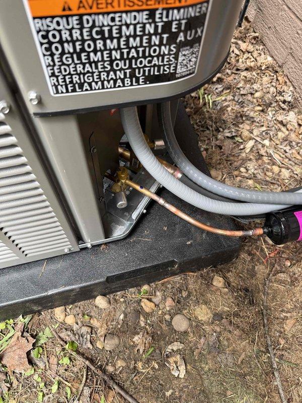 Completed installation of 80% efficiency furnace and air conditioning system. Outdoor Lennox condenser unit was positioned on concrete pad with proper refrigerant line connections, including insulated copper lines secured with appropriate fittings and valves. System was installed per manufacturer specifications with all safety labels and warnings properly displayed.