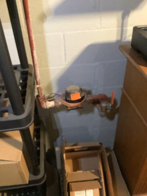 Responded to service call for water intrusion into electrical panel. Upon inspection, identified moisture entry point at exterior meter enclosure where weatherhead conduit penetrates the building envelope. Examined electrical service equipment and confirmed water had compromised panel integrity, creating potential safety hazard. Documented conditions with photographs showing exterior meter installation on weathered brick wall with inadequate sealing at conduit entry point, as well as interior utility area with plumbing equipment in proximity to electrical service. Provided professional assessment and recommendations for proper weatherproofing of service entrance conduit and evaluation of panel replacement due to water damage.
