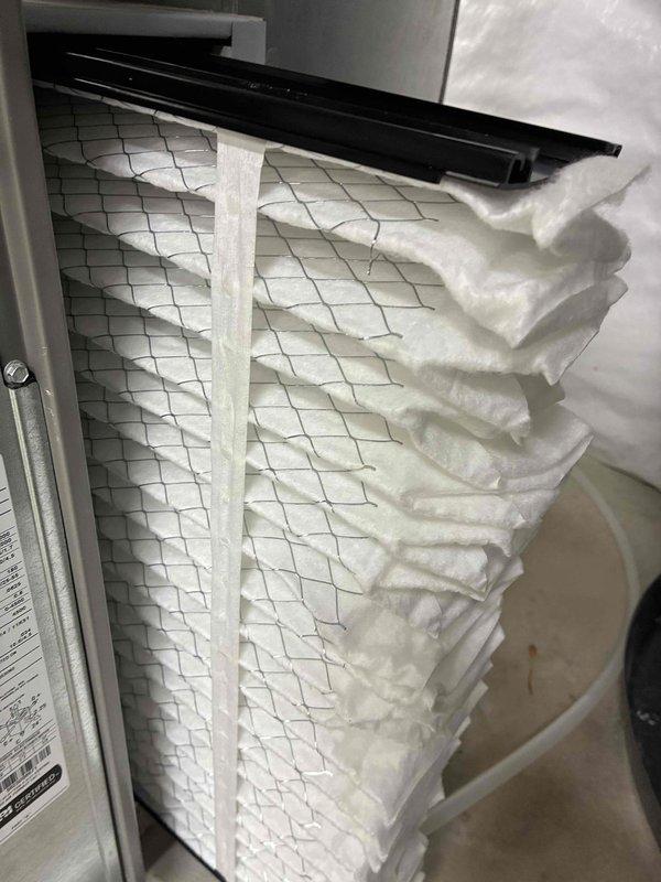 Completed scheduled cooling maintenance visit on 2-year-old air conditioning system. Performed comprehensive inspection of evaporator coil assembly, verifying fin condition and refrigerant line connections. Coil fins appeared clean and intact with no significant debris accumulation. Inspected air filter and documented substantial dust and lint buildup requiring attention. All accessible components photographed for maintenance records. System operational at time of service.