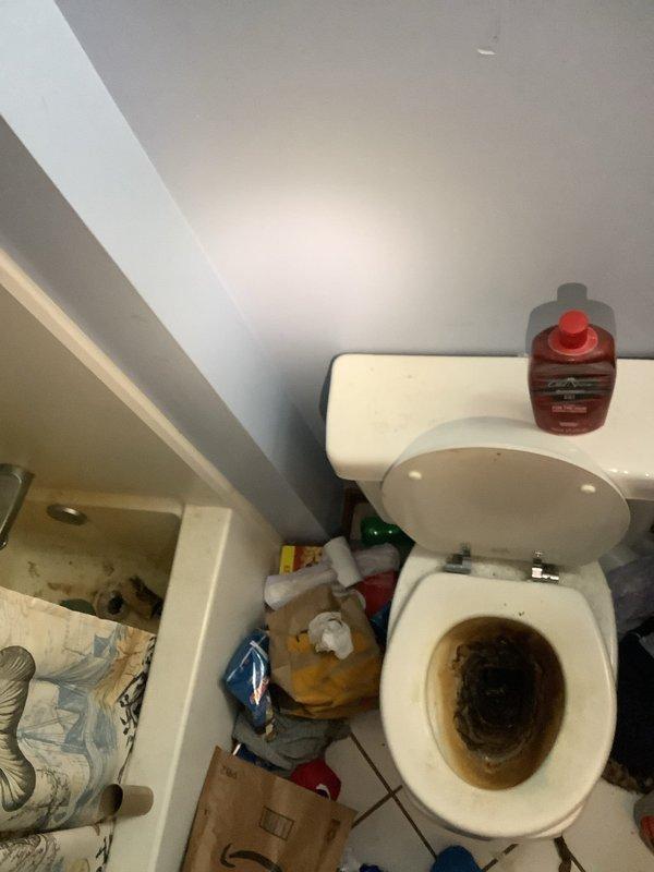 Responded to service call for malfunctioning garbage disposal and loose second-floor toilet. Assessed garbage disposal unit and confirmed motor failure due to burnout. Evaluated second-floor toilet instability caused by broken mounting bolts at the base, which occurred during previous tightening attempt. Documented existing conditions including deteriorated toilet bowl condition and missing floor tiles around toilet base requiring future attention.