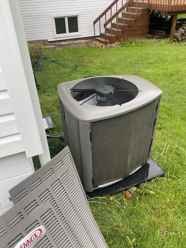 Completed routine maintenance inspection on 2-year-old residential air conditioning system. Performed visual assessment of outdoor condenser unit, confirmed proper installation on platform, verified refrigerant line connections, and documented equipment condition with all components operating within normal parameters.