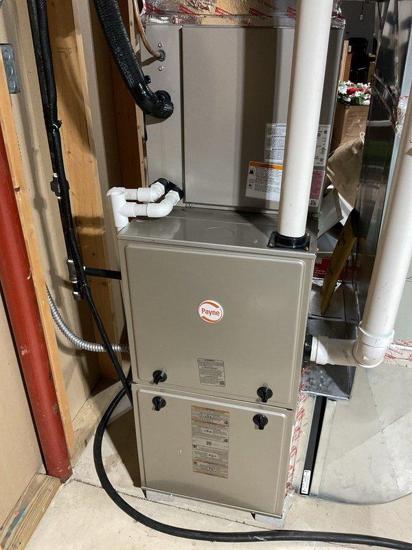 Completed preventive maintenance on Payne brand air conditioning system. Inspected indoor furnace/air handler unit and outdoor disconnect box, verified all electrical connections secure, and confirmed system operational status. Equipment age could not be verified from available manufacturer labels during this maintenance visit.