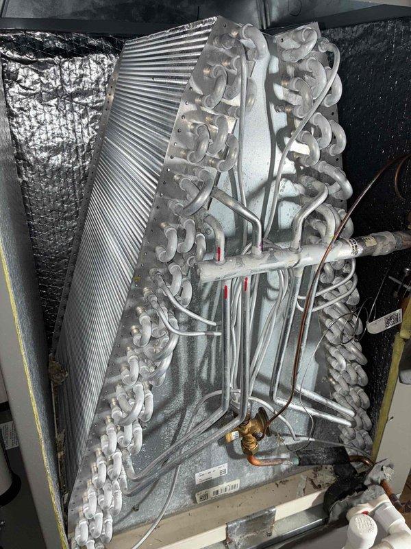 Completed annual air conditioning maintenance on a one-year-old system under MVP agreement. Performed comprehensive inspection of indoor evaporator coil assembly and outdoor condenser unit, verified proper refrigerant line connections and fittings, checked condensate drain pan operation, and confirmed all components are functioning within normal parameters. Unit shows typical dust accumulation for age; condenser coils intact with no visible damage or deterioration noted.