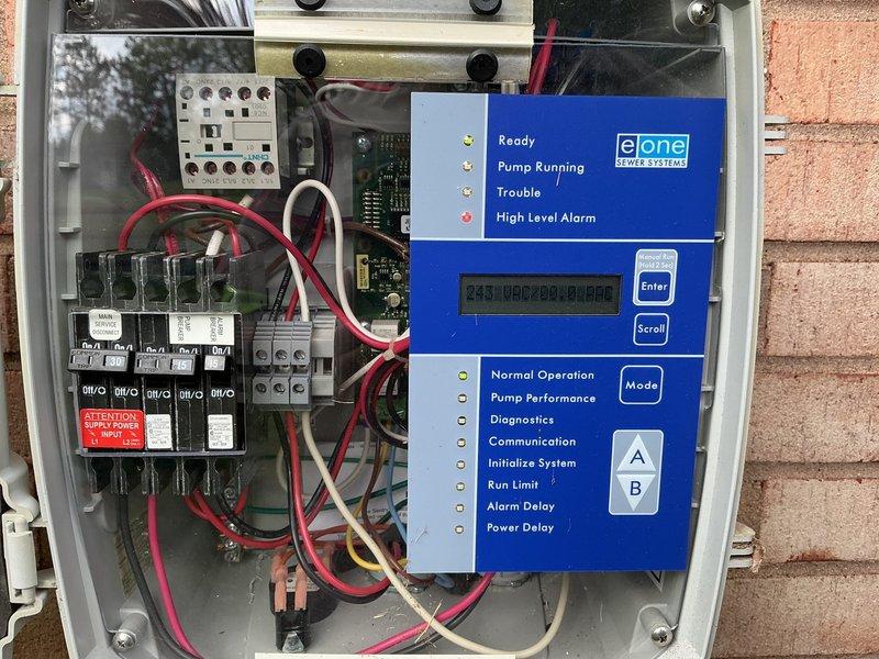 Responded to main sewer system backup caused by lift station malfunction. Inspected e|one grinder pump control panel and exterior housing unit mounted on front yard installation. Documented control system components including digital display interface, electrical contactors, terminal blocks, and alarm indicators showing system status and diagnostic functions. Coordinated with Superior for scheduling of specialized grinder pump service to resolve the backup issue.