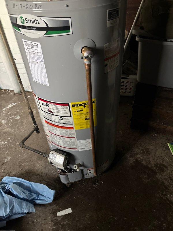 Replaced heavily corroded temperature and pressure relief valve on A.O. Smith water heater due to extensive mineral buildup and scale accumulation that compromised the valve's functionality. Additionally, installed new closet bolts and wax ring on toilet to restore proper seal and eliminate leakage at the base fixture.