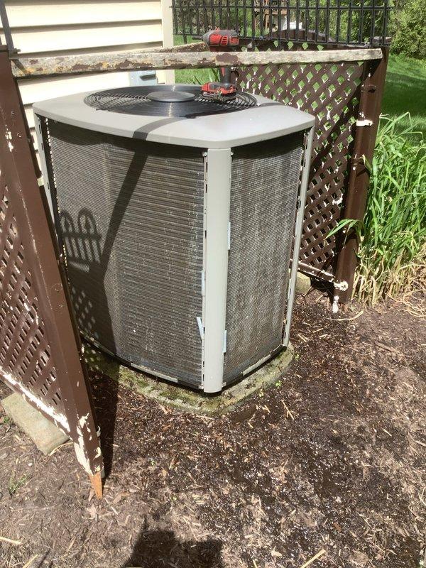 Completed preventive maintenance service on Lennox outdoor condensing unit for MVP customer. Performed standard inspection of equipment, verified proper operation of compressor and condenser fan motor, and documented unit condition with photographs showing system installed in latticed enclosure with adequate clearance for airflow. Unit found operating within normal parameters with no immediate repairs required.