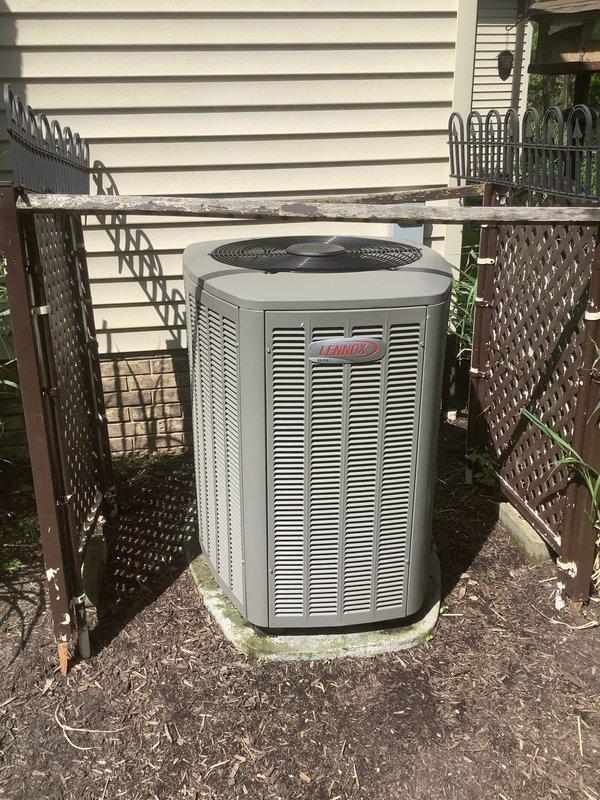 Completed preventive maintenance service on Lennox outdoor condensing unit for MVP customer. Performed standard inspection of equipment, verified proper operation of compressor and condenser fan motor, and documented unit condition with photographs showing system installed in latticed enclosure with adequate clearance for airflow. Unit found operating within normal parameters with no immediate repairs required.