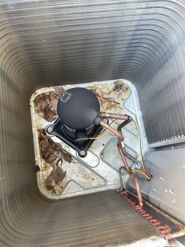 # HVAC Tune-Up Completed

Performed comprehensive preventive maintenance service on a five-year-old residential air conditioning system. Conducted visual inspection of internal components including compressor assembly, refrigerant lines, electrical connections, and condensate management system. Documentation photography revealed moderate wear on drain pan with visible staining and discoloration consistent with normal moisture exposure over the unit's service life. All copper refrigerant lines, electrical wiring, and compressor mounting verified secure and operational. System components functioning within normal parameters upon completion of tune-up procedures.