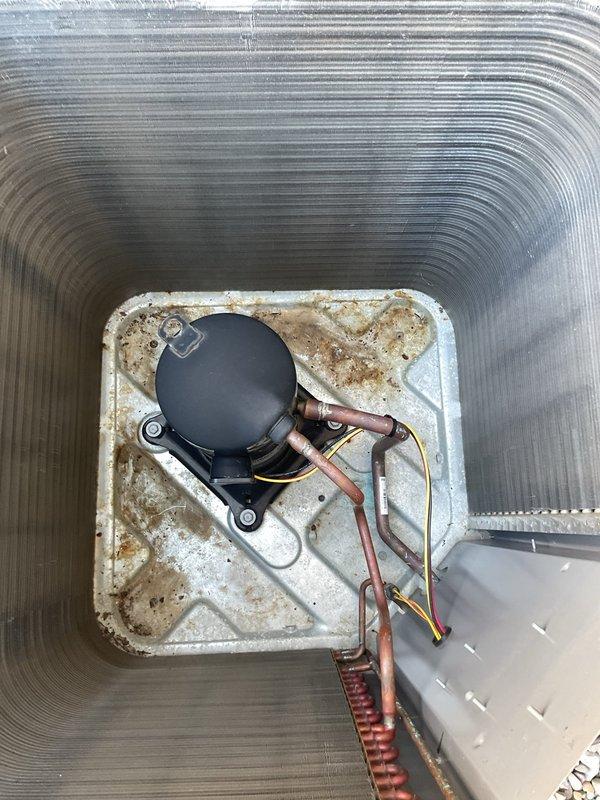 # HVAC Tune-Up Completed

Performed comprehensive preventive maintenance service on a five-year-old residential air conditioning system. Conducted visual inspection of internal components including compressor assembly, refrigerant lines, electrical connections, and condensate management system. Documentation photography revealed moderate wear on drain pan with visible staining and discoloration consistent with normal moisture exposure over the unit's service life. All copper refrigerant lines, electrical wiring, and compressor mounting verified secure and operational. System components functioning within normal parameters upon completion of tune-up procedures.