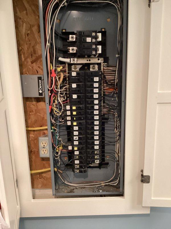 Responded to service call for circuit breaker tripping after garage refrigerator installation. Inspected electrical panel and identified overloaded circuit causing nuisance tripping. Evaluated existing breaker configuration and wiring conditions within main service panel. Determined dedicated circuit was required for refrigerator load to prevent continued breaker trips and ensure safe operation of appliance.