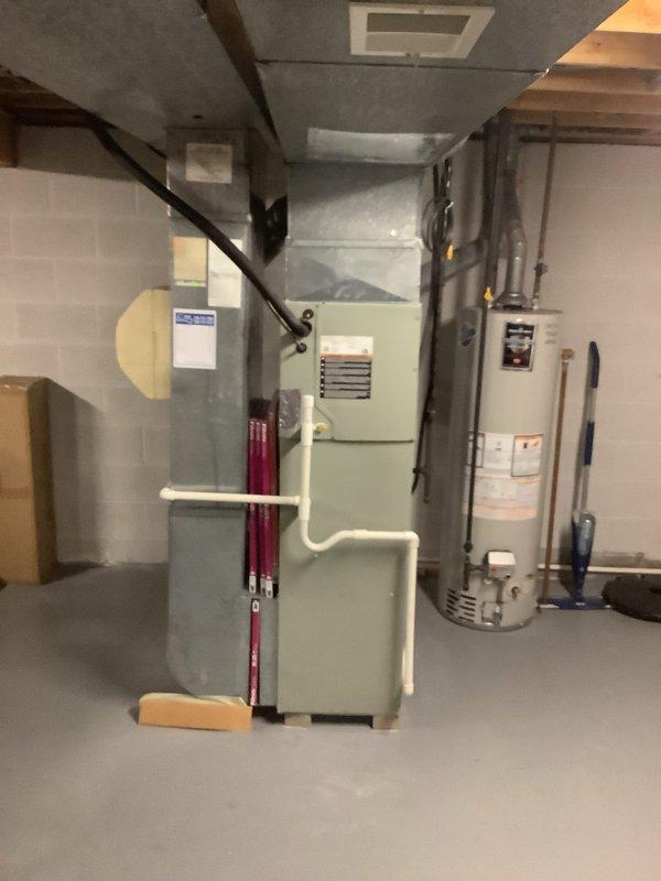 Completed full HVAC system installation including 80% AFUE furnace and air conditioning unit with humidifier integration. Installed new furnace in basement mechanical room with proper venting using white PVC piping, connected galvanized metal supply ductwork with trunk line distribution, and integrated humidifier into the system for whole-home comfort control. All equipment properly positioned, leveled, and secured with appropriate clearances maintained for service access, electrical connections completed to code, and system tested for proper operation across all components.
