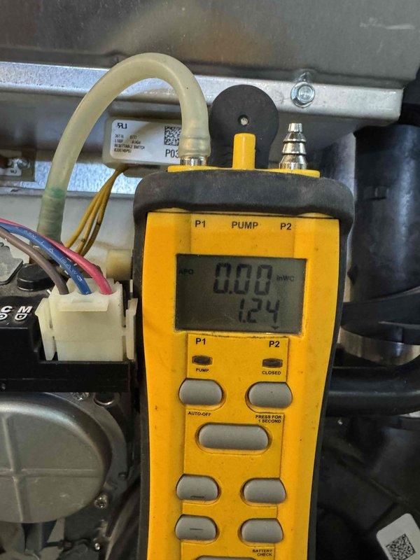 Responded to no-heat call on 11-year-old furnace blowing cold air. Upon arrival, performed diagnostic testing of gas valve and pressure switch operation using manometer to measure pressure differentials within the system. Measured pressure switch readings showing 0.00 and 1.24 inches water column, indicating insufficient pressure to close the pressure switch and allow gas valve to energize. Inspected gas valve assembly, electrical connections, and wiring harness for proper operation. Tested pressure switch operation and confirmed switch was not making at current system pressures. Issue identified as pressure switch failure or insufficient draft pressure preventing normal heating cycle. Documented system readings and component conditions with diagnostic equipment for service records.