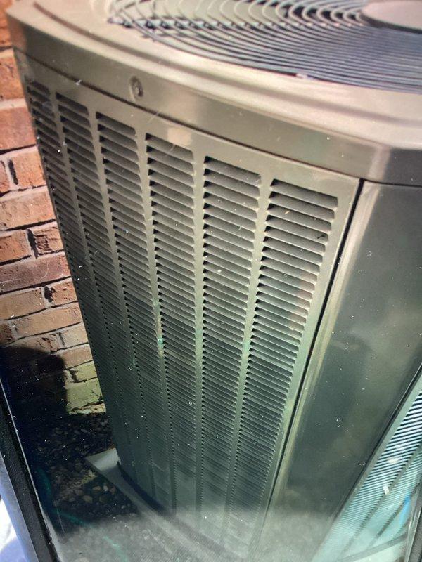 Performed routine maintenance visit on 11-year-old air conditioning system for MVP customer. Upon callback request, conducted additional inspection to assess potential storm damage to outdoor condenser unit and internal components. Documented equipment condition with photographs showing outdoor unit positioned against brick wall with visible surface wear on casing, and internal coil assembly displaying minor debris accumulation and condensation patterns consistent with normal operation.