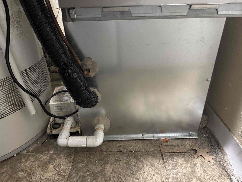 Responded to service call for hail-damaged A/C unit. Conducted comprehensive assessment of outdoor condensing unit and foundation pad. Unit confirmed operational despite severe storm damage to concrete pad and mounting base. Documented extensive damage to equipment foundation requiring complete replacement. Photographed damaged concrete pad showing deterioration and structural failure, as well as interior components including refrigerant lines, condensate drainage system, and electrical connections. Assessment completed to provide detailed repair estimate for warranty claim submission, including costs for equipment removal, foundation replacement, and reinstallation of functional condensing unit.