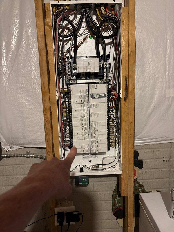 Installed dedicated 50-amp circuit for hot tub installation with load shed module for generator compatibility. Consolidated existing panel GFCI and smoke detector breakers to create two available spaces in main electrical panel. Routed new circuit through joist bay from panel, running parallel to existing ductwork and waterlines across basement ceiling to rear of residence. Installed customer-supplied disconnect at required 6-foot distance from hot tub, mounted on deck fascia board, and connected whip to hot tub control panel. All work completed per electrical code requirements with load management system integrated for generator operation.
